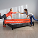 Two women high fiving over the platform bed