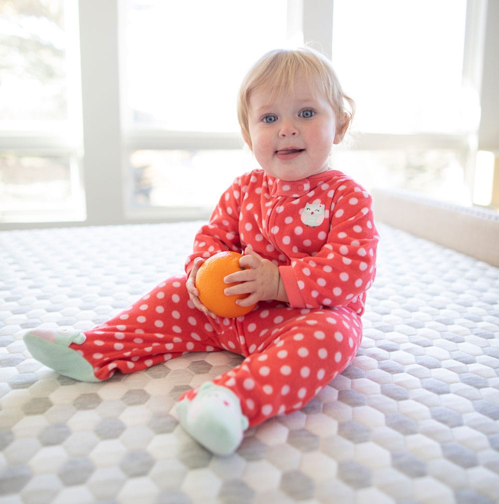 Baby sitting on memory foam mattress