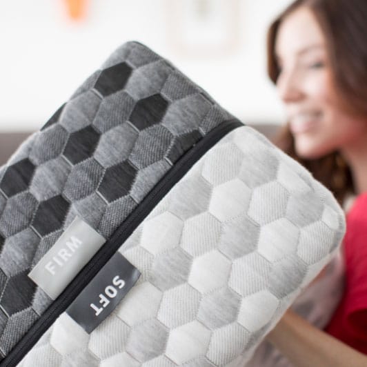 Woman flipping memory foam mattress