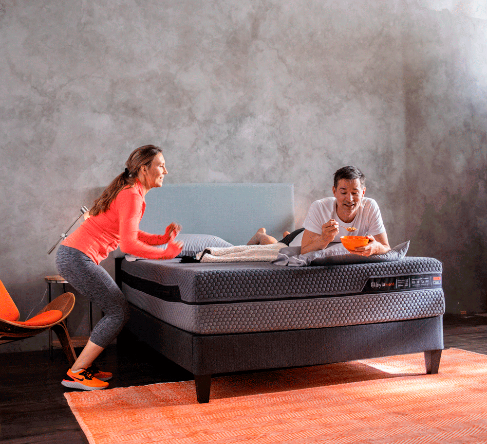 Woman jumping on hybrid mattress