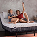 Couple laying on mattress and using an adjustable base