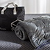 Weighted blanket and carry bag on a mattress